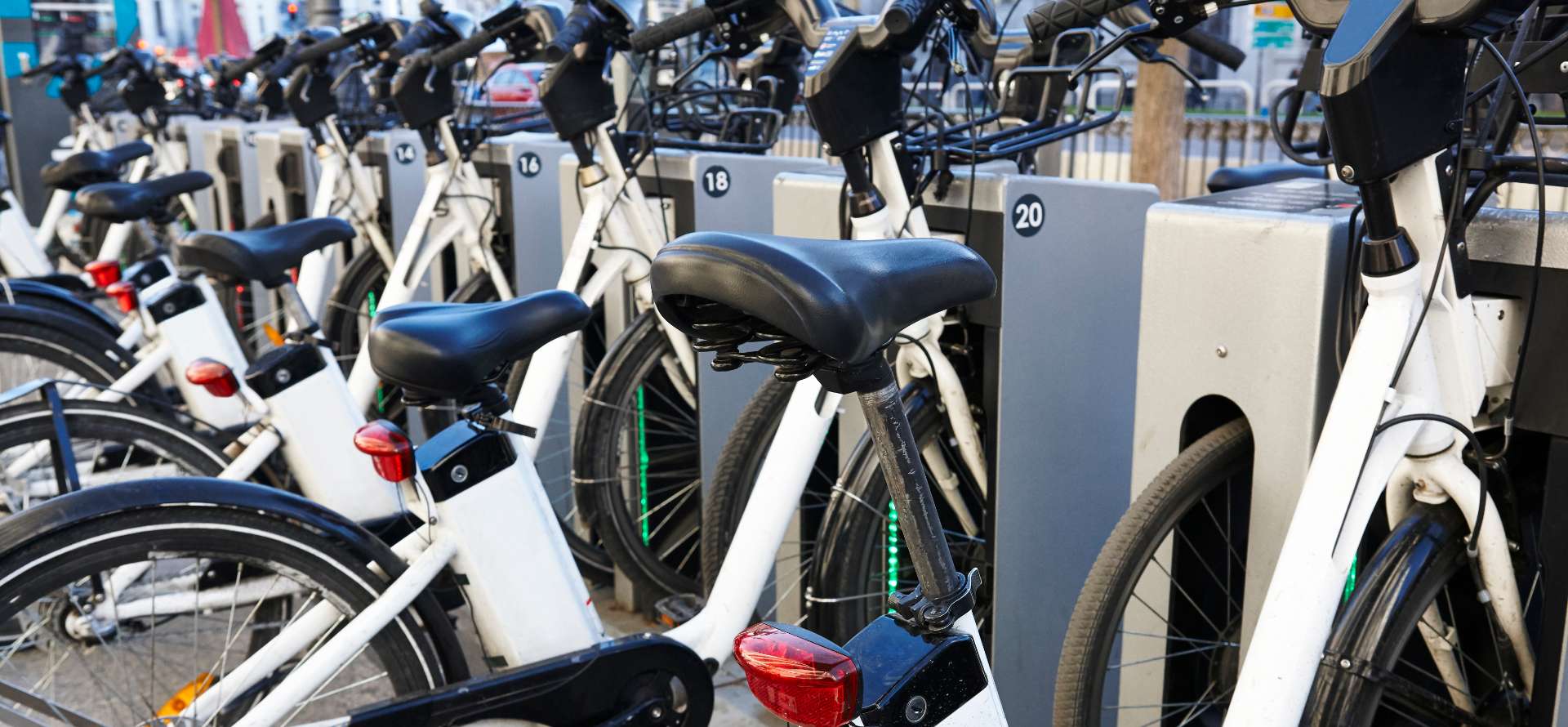 Outdoor bike sharing station with rows of parked bicycles in an urban mobility setting
