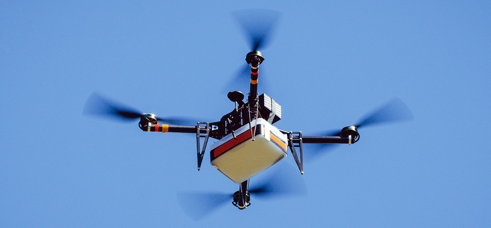 Autonomous UAV delivery cargo drone flying during an edge AI-powered logistics mission
